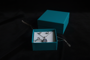 Silver zirconia jewelry set on velvet surface